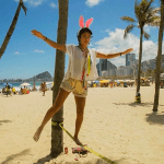 Esperanza walking on a low-to-the-ground tightrope on a beach in Rio de Janeiro