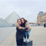 two girls in front of the Louvre Pyramid