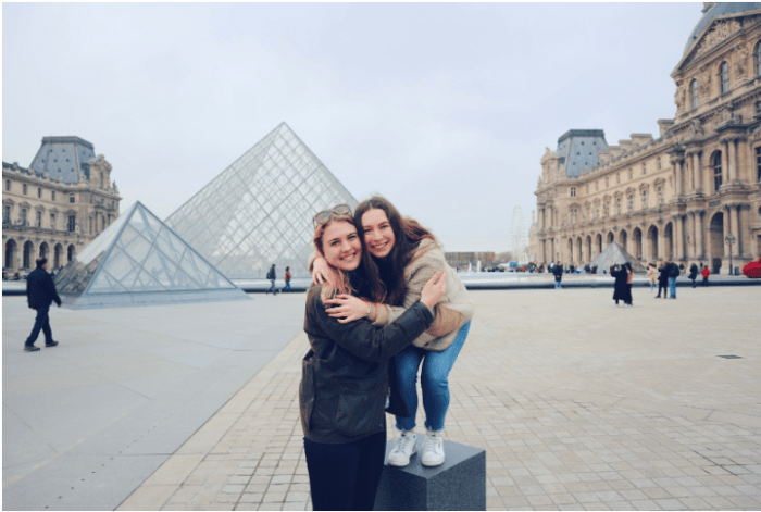 two girls in front of the Louvre Pyramid