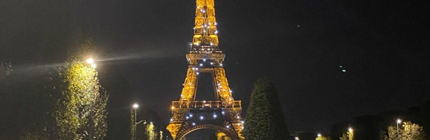 The Eiffel Tower from afar lit up at night