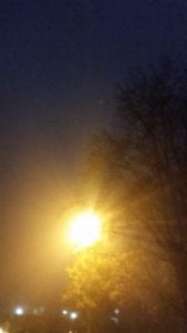 A street lamp shines on a foggy night at Oxford