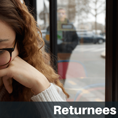 Text on image "Returnees": Side of female student's face sitting in cafe window