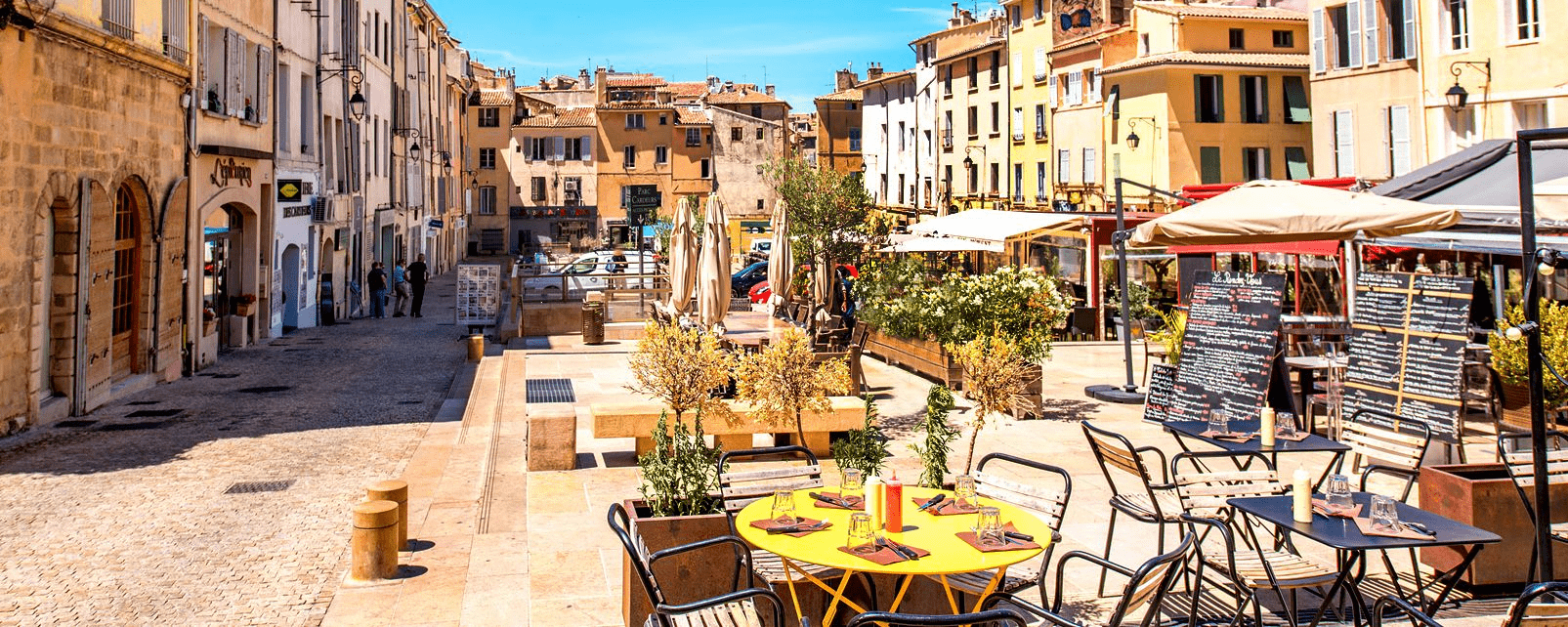 View of street with cafe and outdoor seating in Aix-en-Provence, France