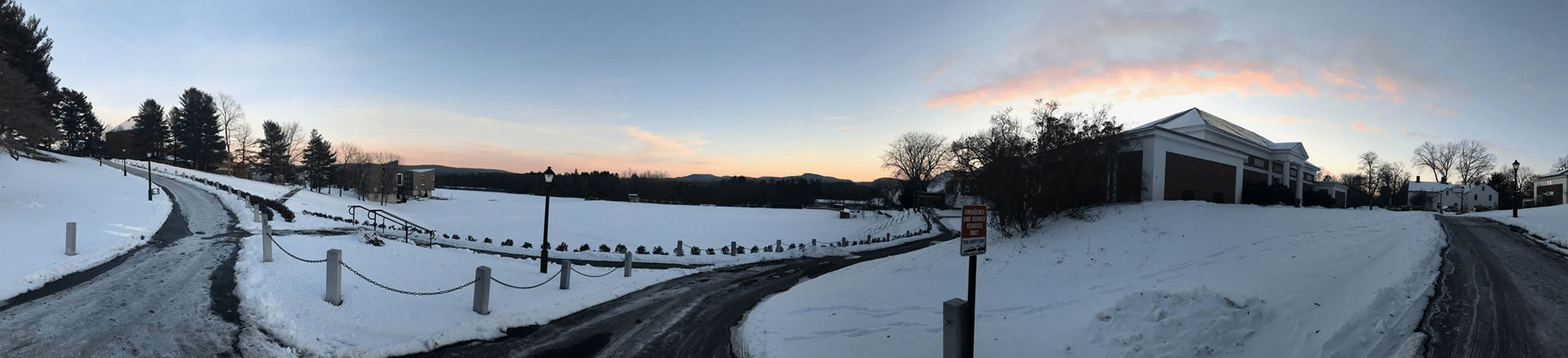 Landscape in Amherst with sunset and snow covered field
