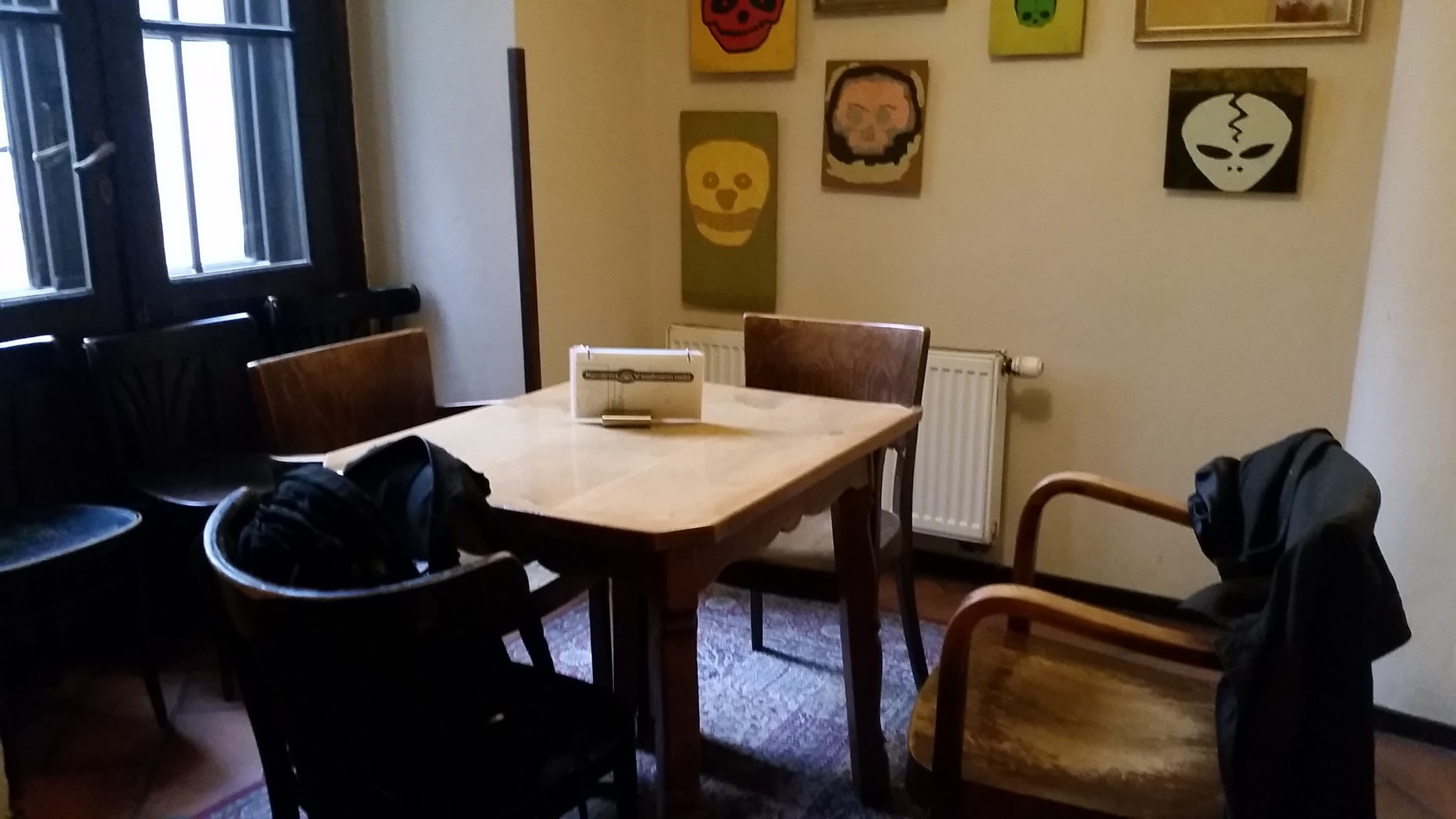 Back room in a small cafe with table and chairs