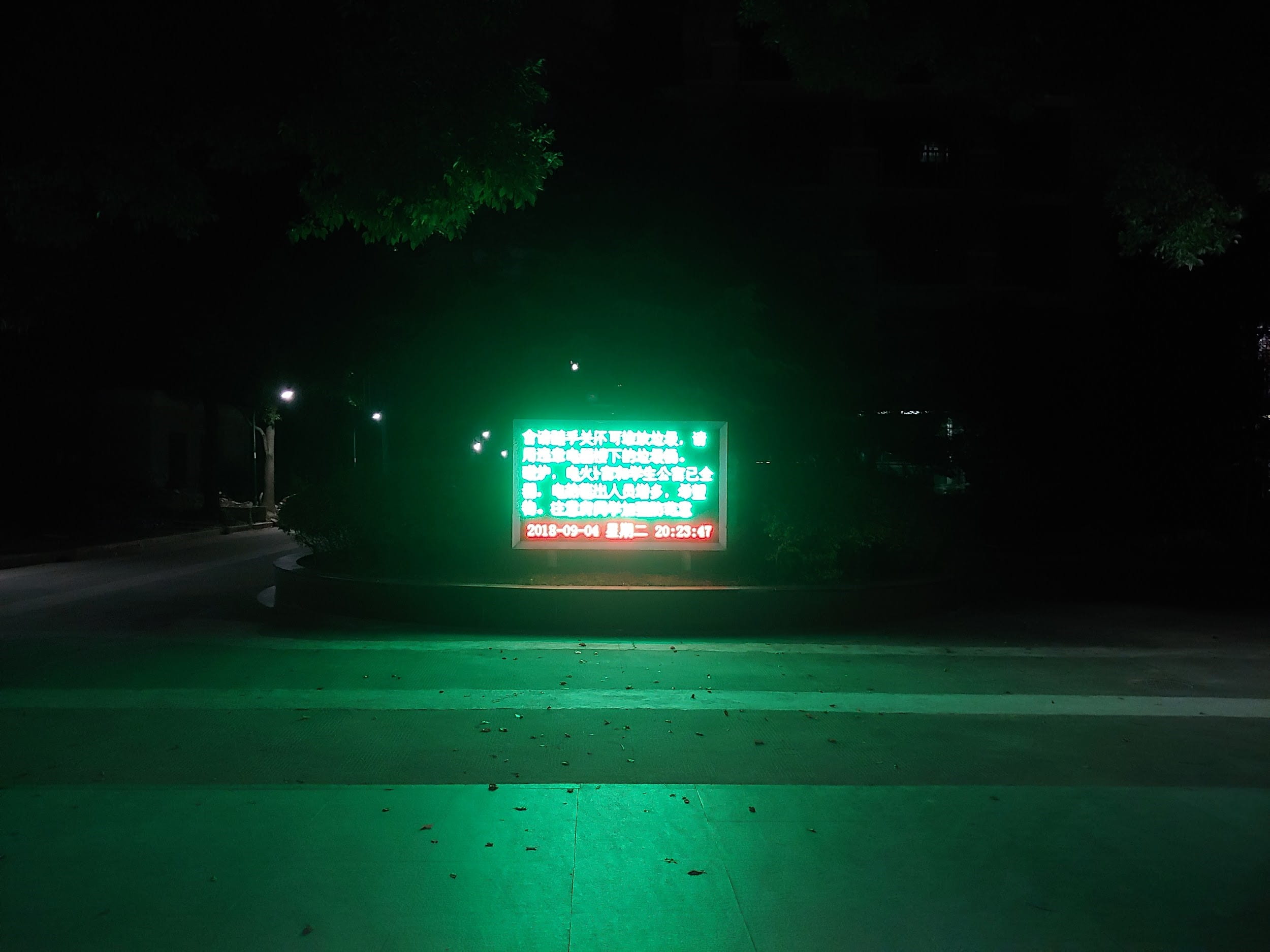 neon green welcome sign in front of dorm in Shanghai