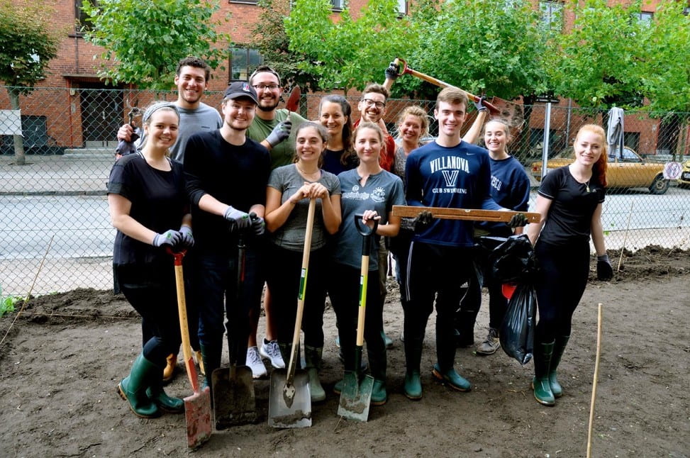 Talia with housemates volunteering and holding shovels