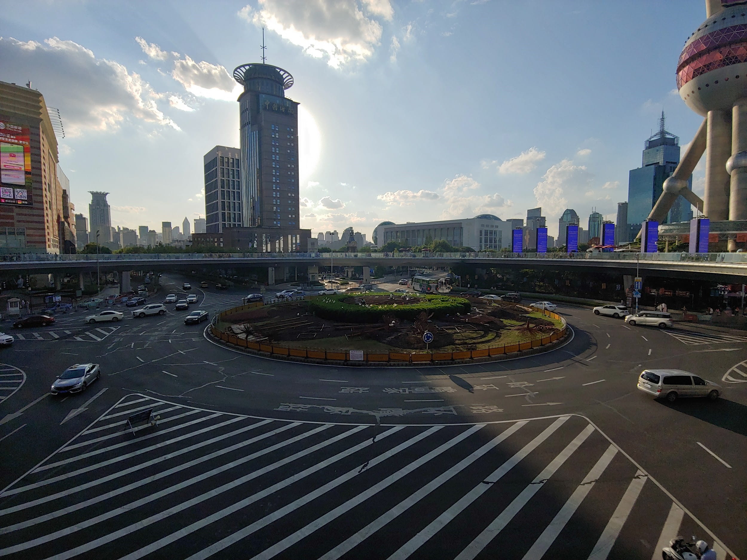 Roundabout in Shanghai with skyline and blue sky in the background