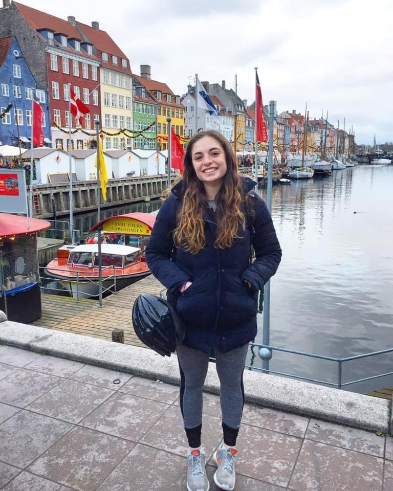 Talia standing in front of colorful houses in Copenhagen