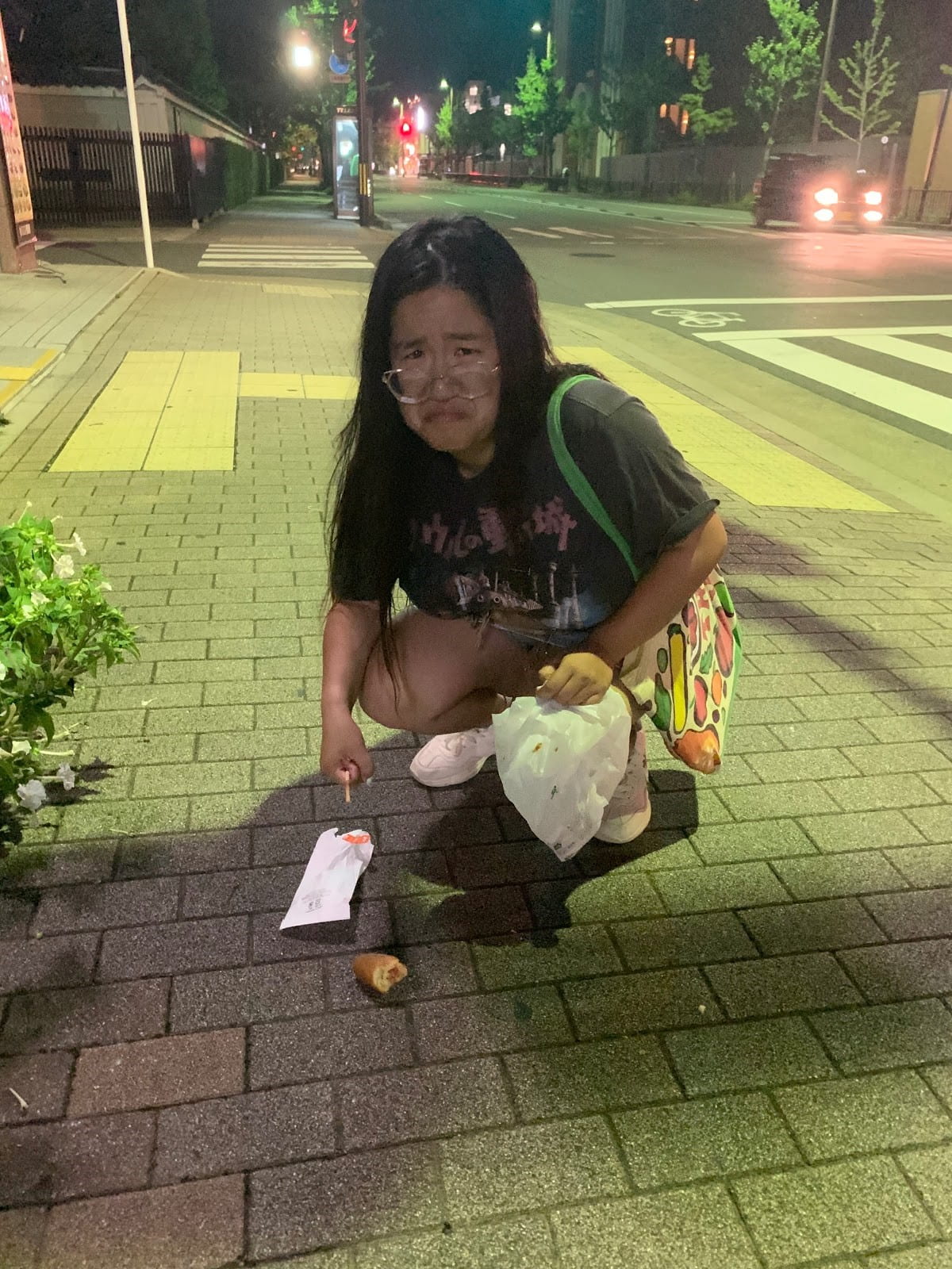Cy makes a sad face after dropping her hot dog
