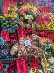 Onions and assorted vegetables on produce stand