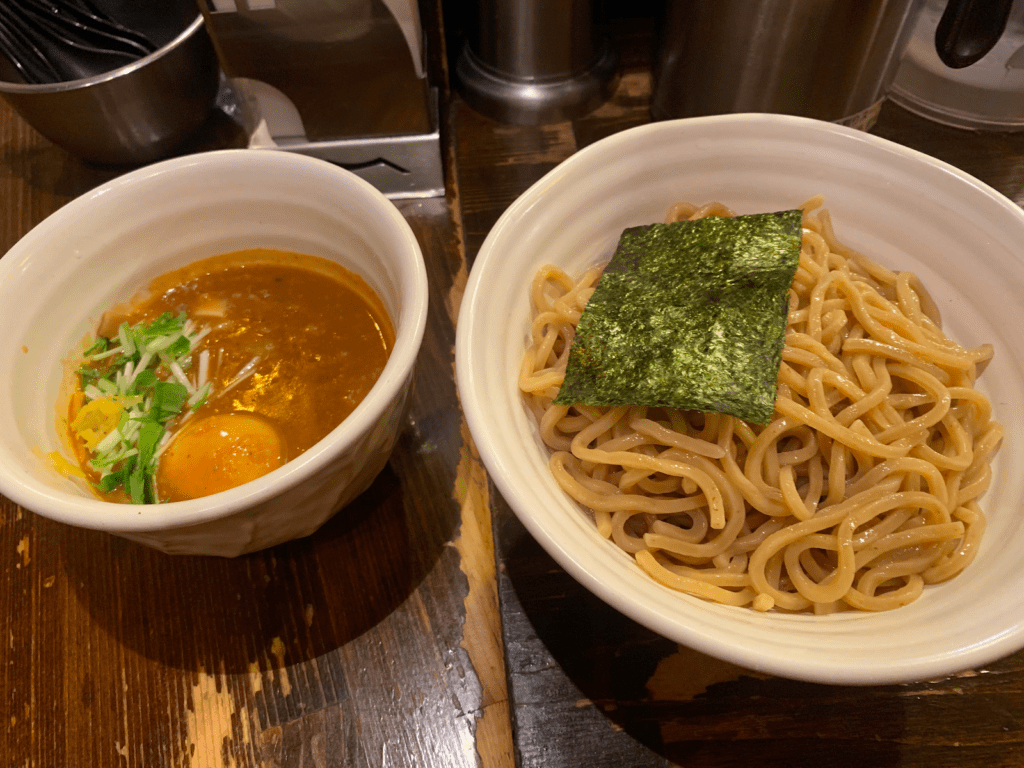 A serving of Tsukemen ramen- a bowl of noodles with a bowl of soup dipping base next to it