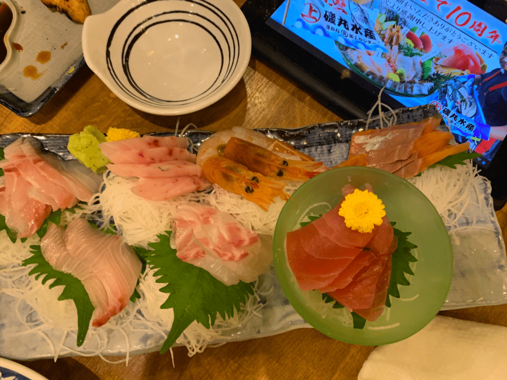 A serving plate with sashimi and garnishes 